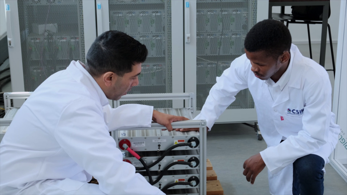 Two people looking at item