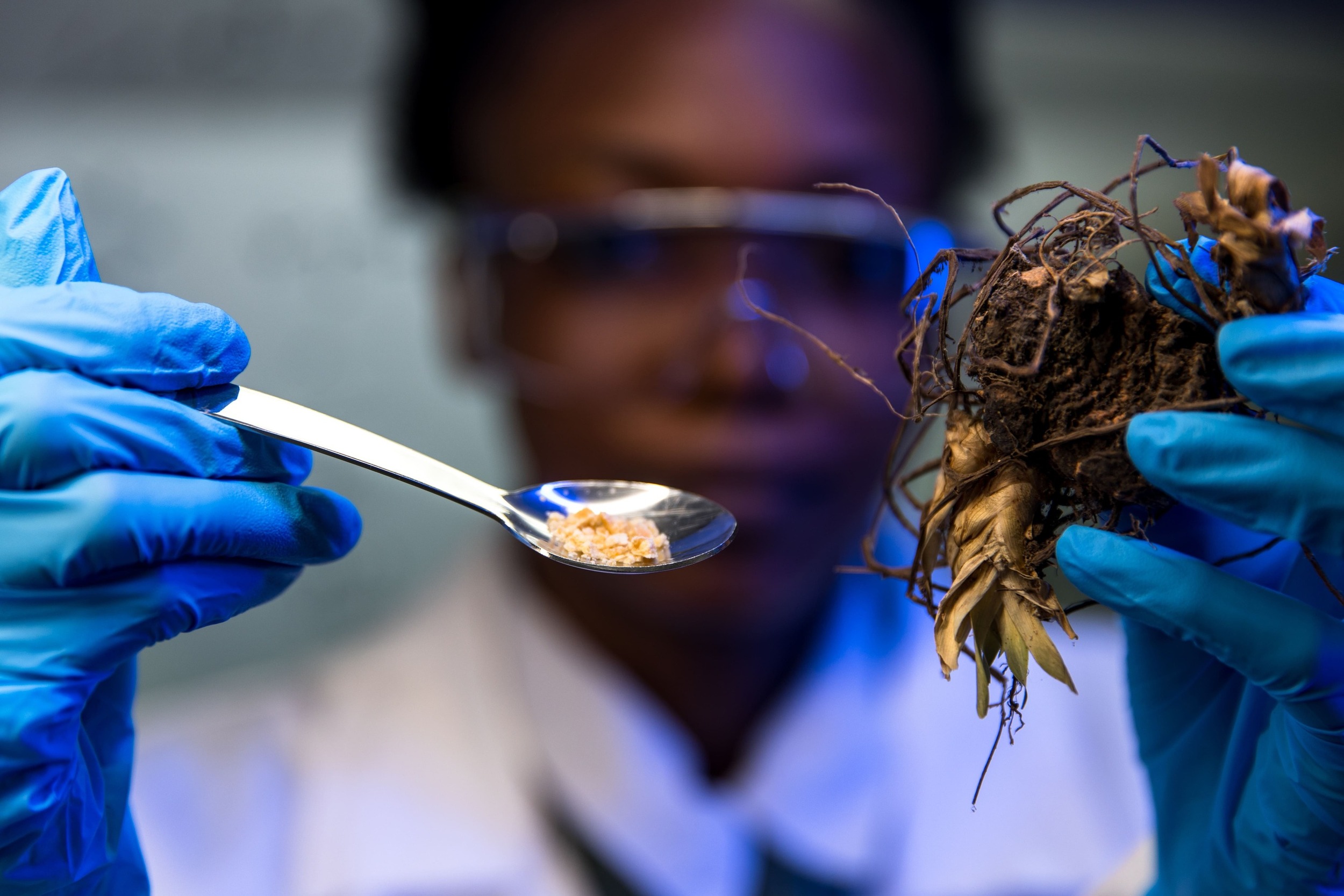 Scientist holding up two items