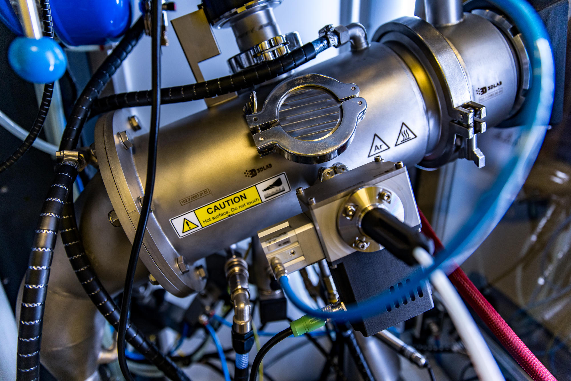 Hand holding a container with yellowish liquid