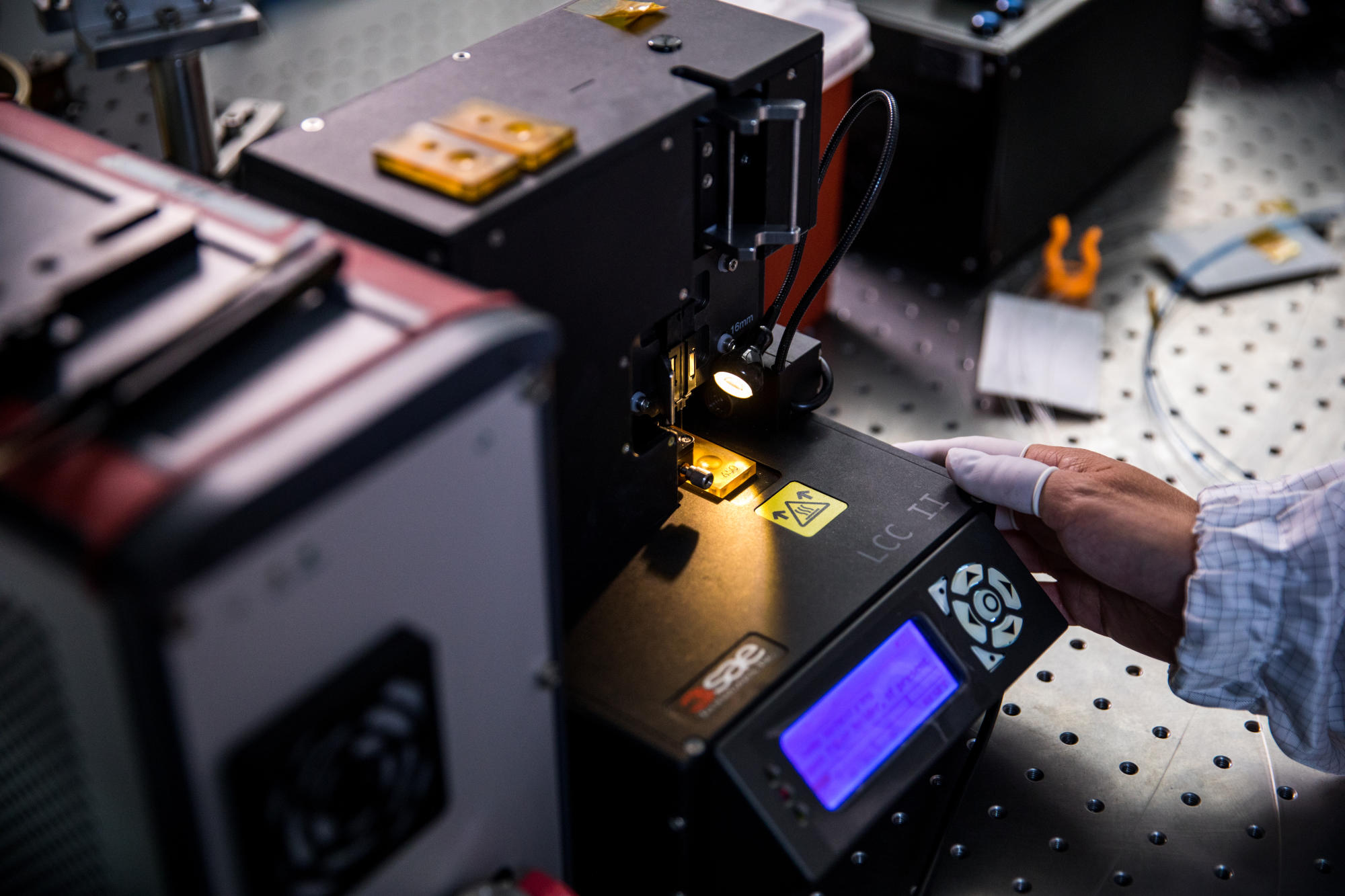 Hand holding a container with yellowish liquid