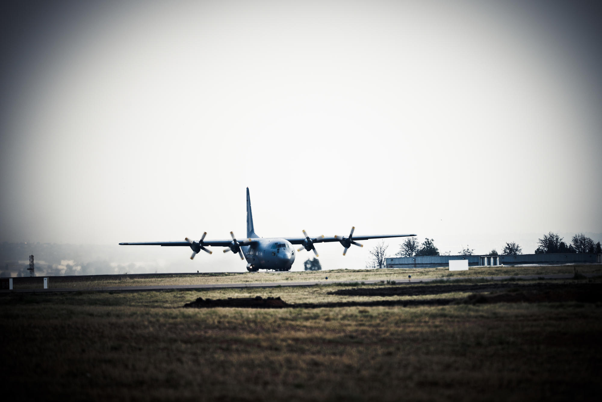 Hand holding a container with yellowish liquid