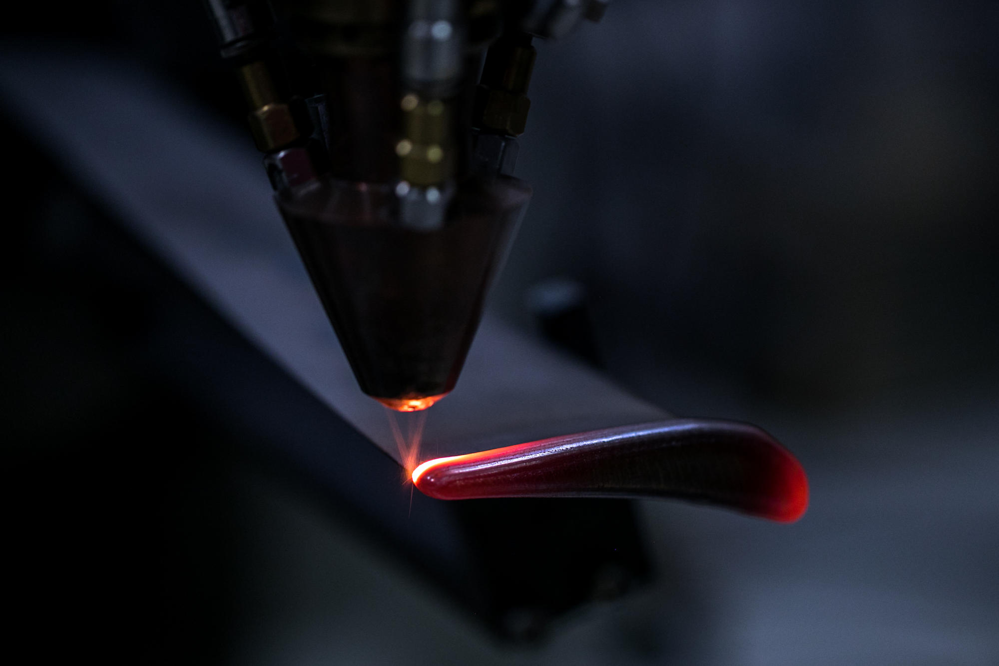 Hand holding a container with yellowish liquid