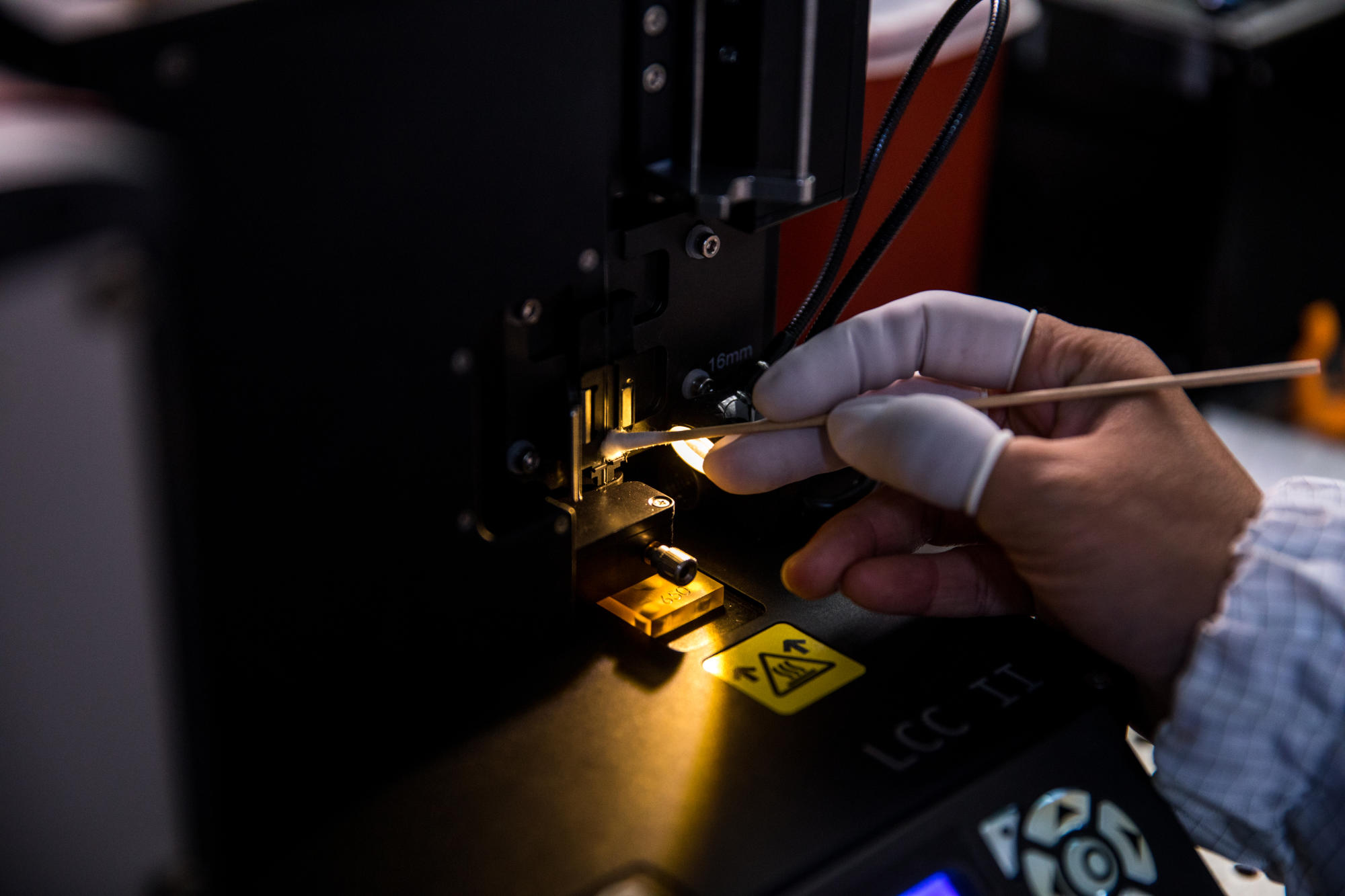 Hand holding a container with yellowish liquid