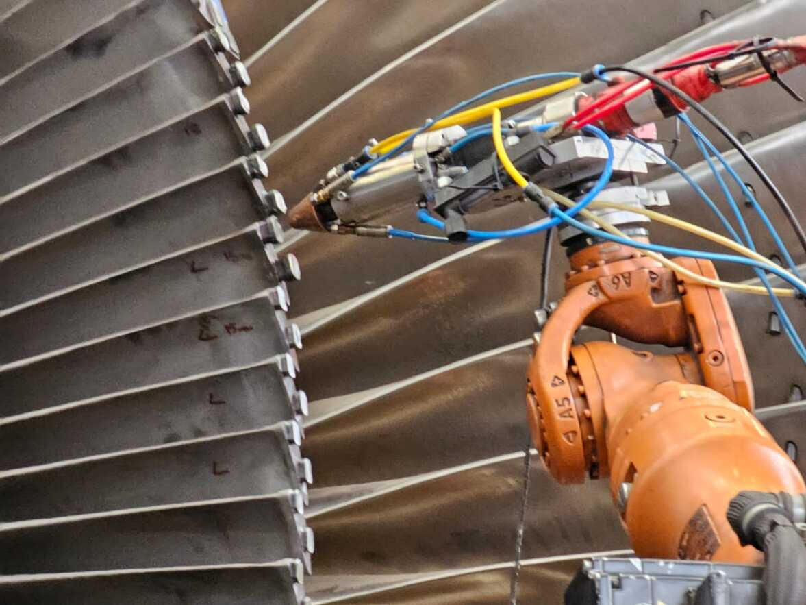 Hand holding a container with yellowish liquid