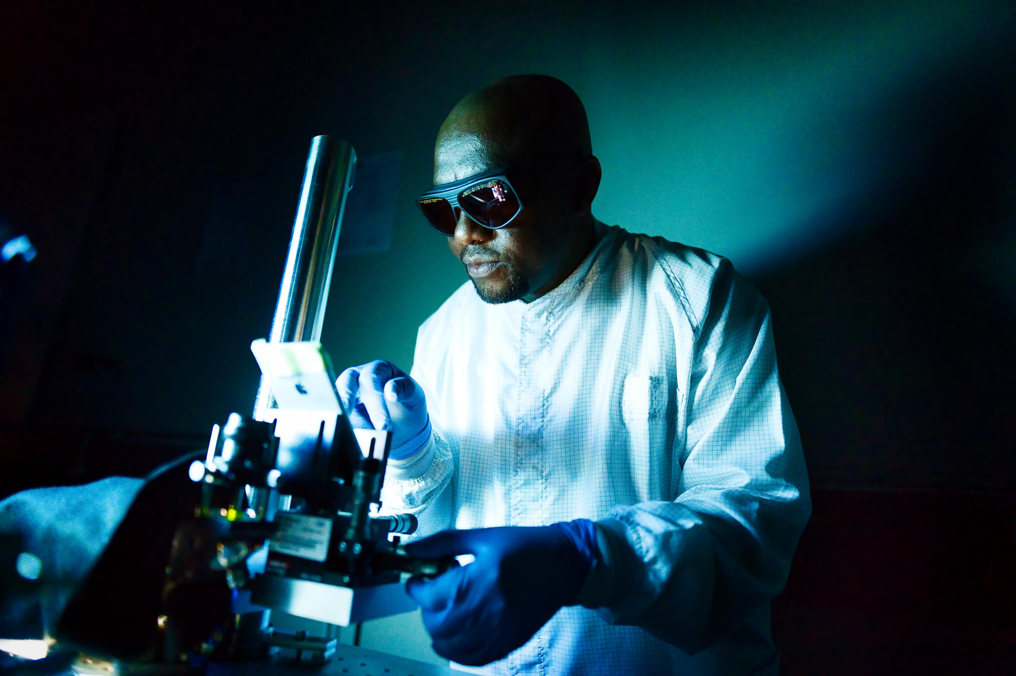 Hand holding a container with yellowish liquid