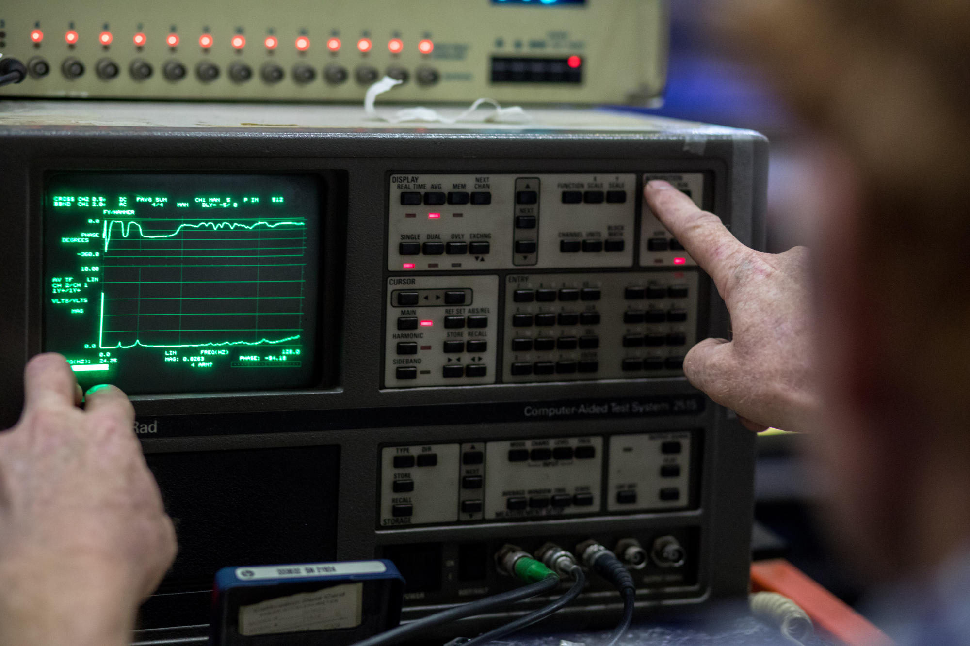 Hand holding a container with yellowish liquid