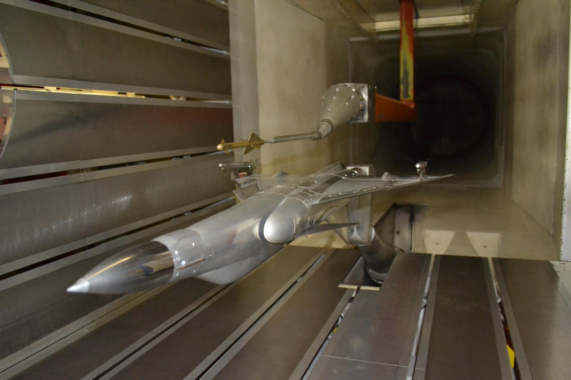 Hand holding a container with yellowish liquid