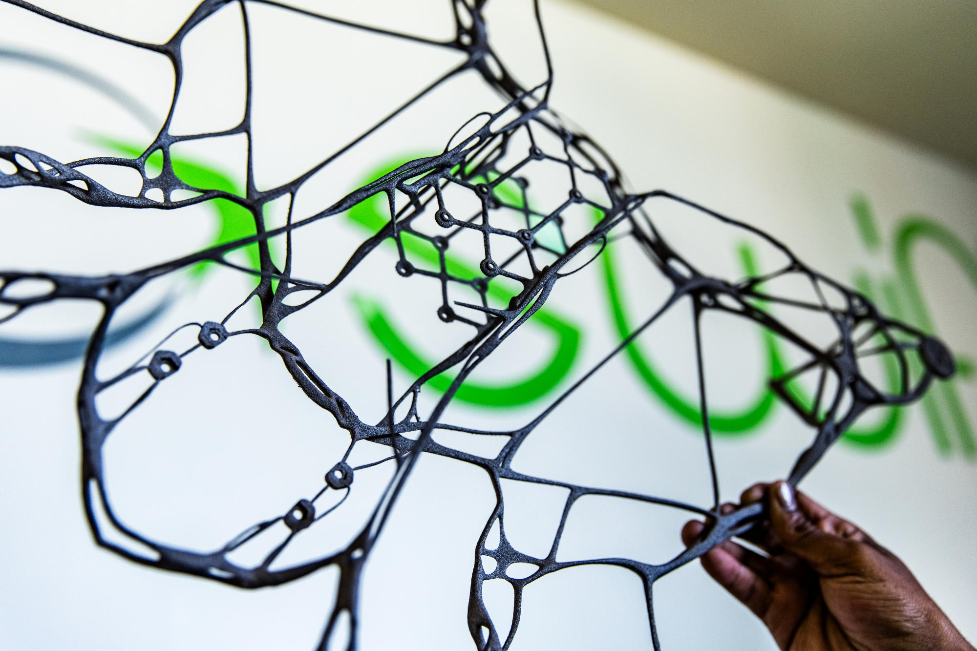 Hand holding a container with yellowish liquid