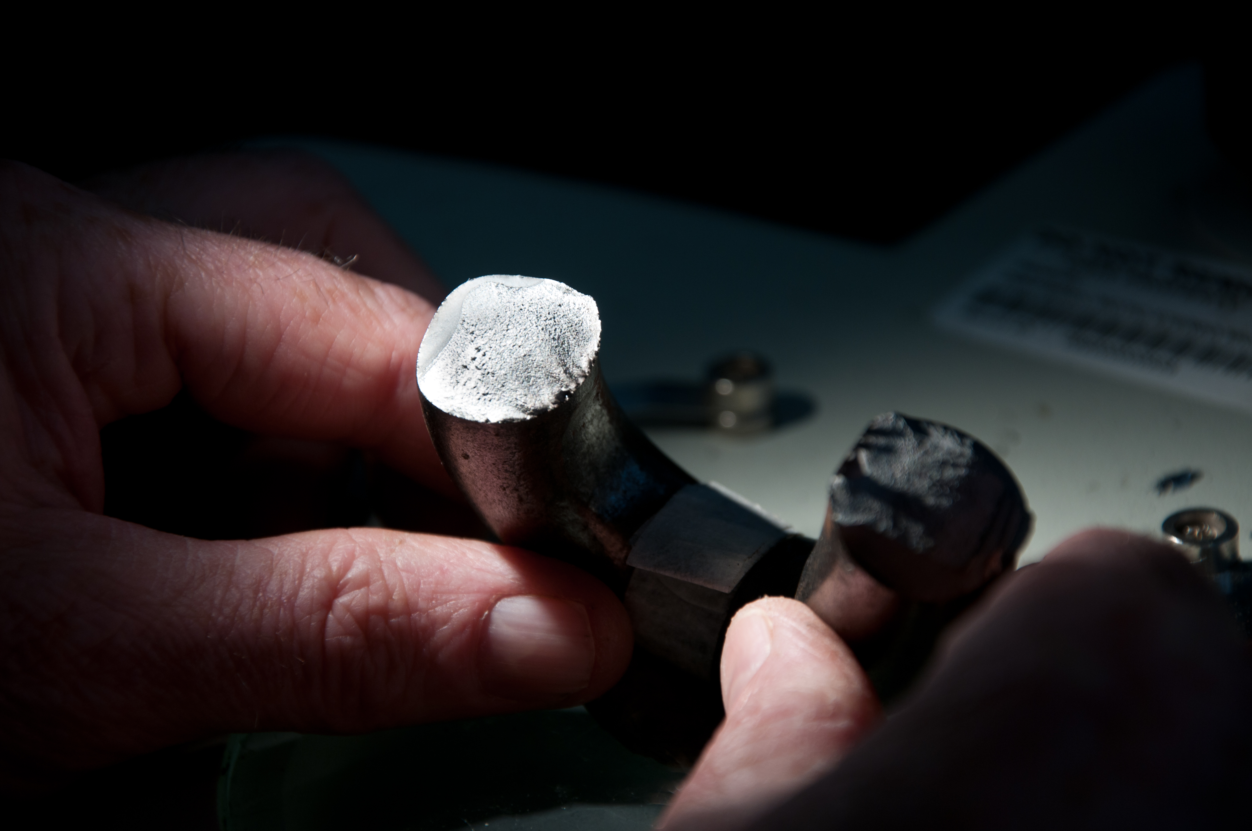 Hand holding a container with yellowish liquid