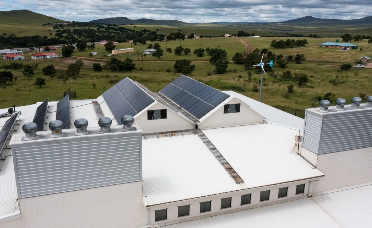 Building with field and mountain in the background