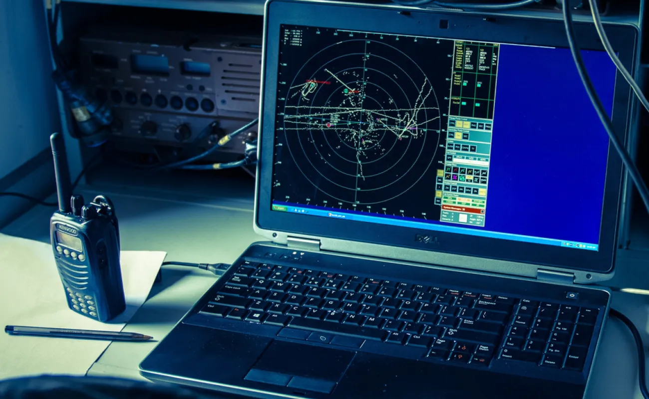 Computer and walkie talkie on desk