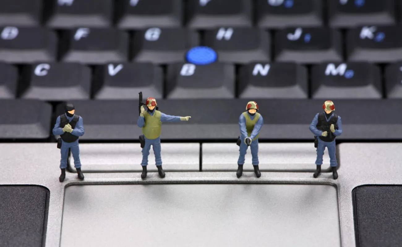 Hand holding a container with yellowish liquid