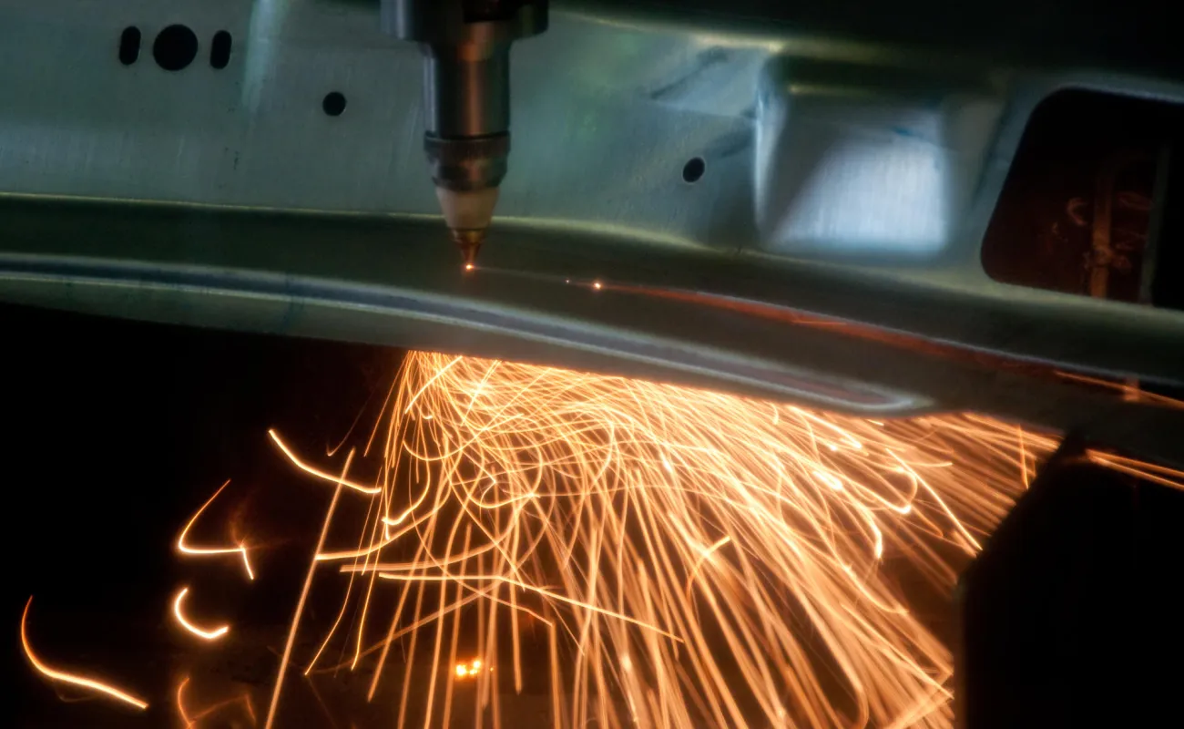 Hand holding a container with yellowish liquid
