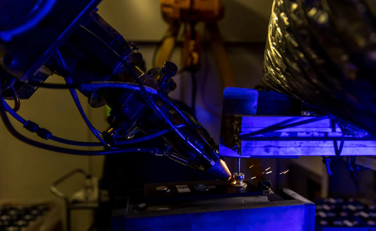 Hand holding a container with yellowish liquid