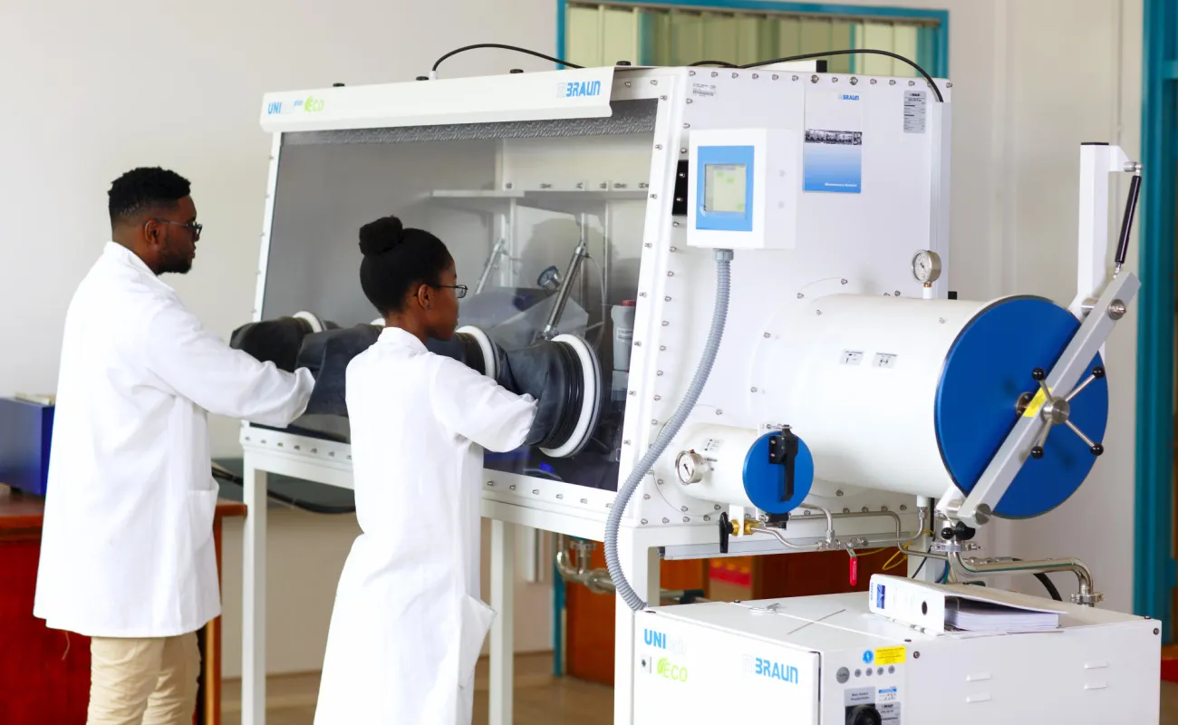 Hand holding a container with yellowish liquid